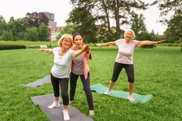 istock Senior Group Yoga Session in Park with Instructor 2181860067