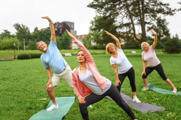 istock Outdoor Yoga Class for Seniors with Asian Instructor 2181860073
