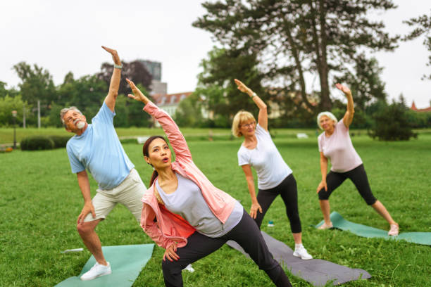 istock Senior Group Yoga Session in Park 2181860074