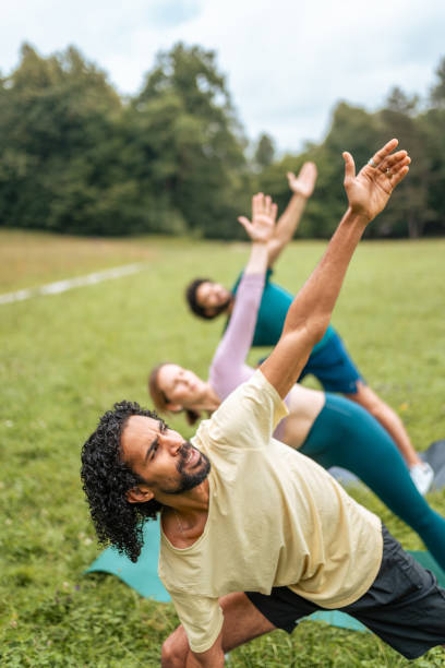 Diverse Group Engages in Park Yoga Session