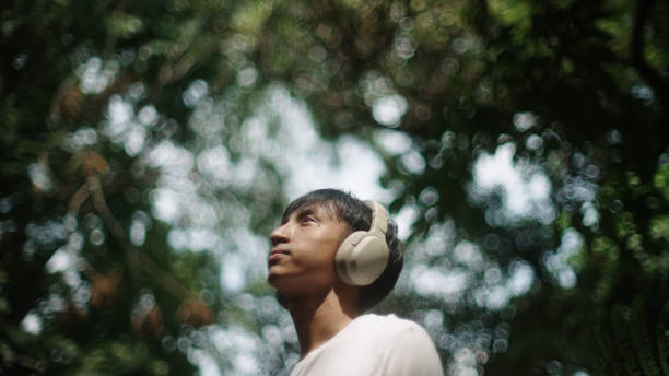 istock Man wear headphones while relaxing in nature. 2181861497