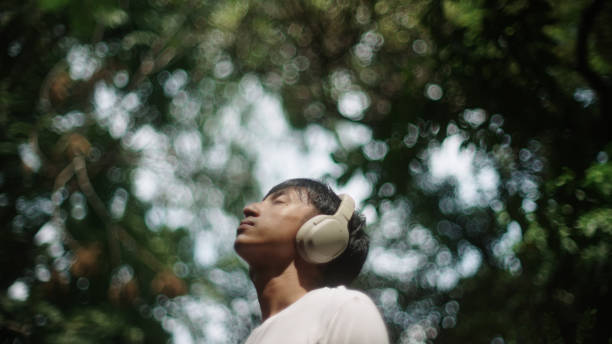 istock Man wear headphones while relaxing in nature. 2181861501
