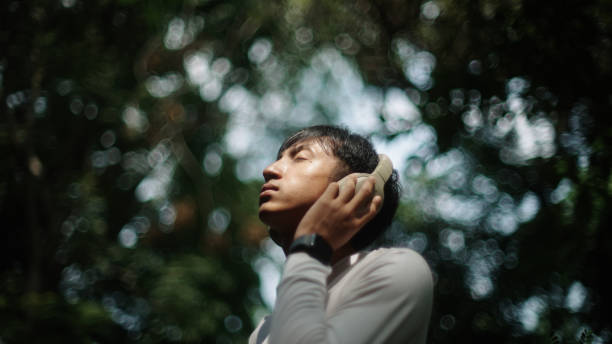 istock Man wear headphones while relaxing in nature. 2181861532