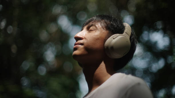 istock Man wear headphones while relaxing in nature. 2181861539