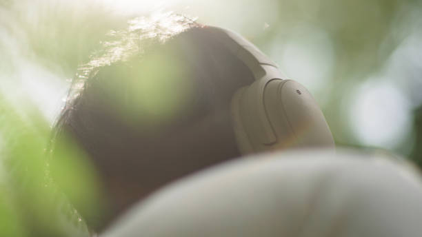 Asian man relax listening while stay in nature.