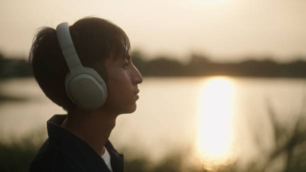 istock Man listening music by the river. 2181861600