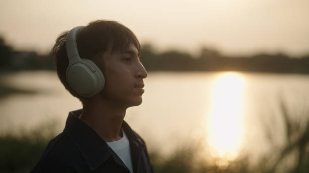 istock Man listening music by the river. 2181861601