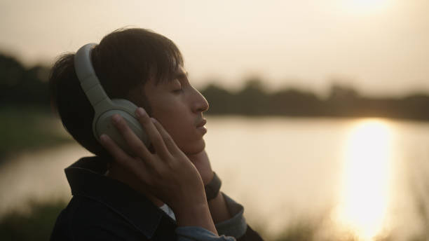istock Man listening music by the river. 2181861604