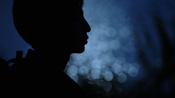 In silhouette of man enjoy moment by the river at night.