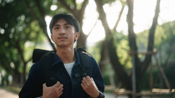 istock Asian man walking at green environment. 2181861970