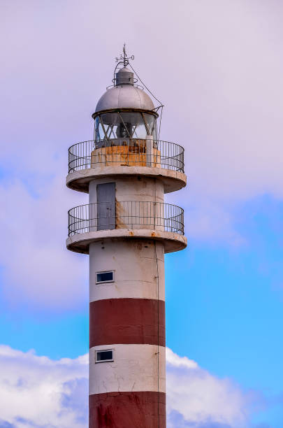 istock A lighthouse with a red and white striped tower 2181863166