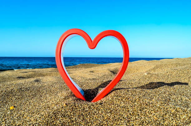 istock A red heart is carved into the sand on a beach 2181863268