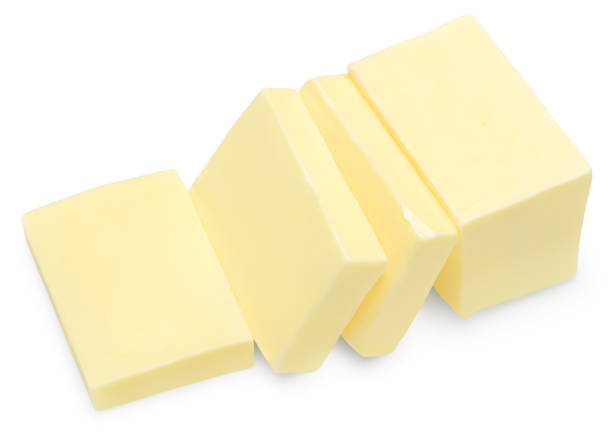 Butter on white plate isolated on white background, close up.