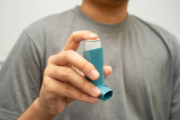 istock Asthma and chronic obstructive pulmonary disease COPD, Asian young man using metered dose inhaler MDI. 2181864861
