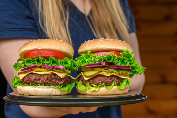 istock The waitress at the bar serves delicious beef cheeseburgers 2181865758