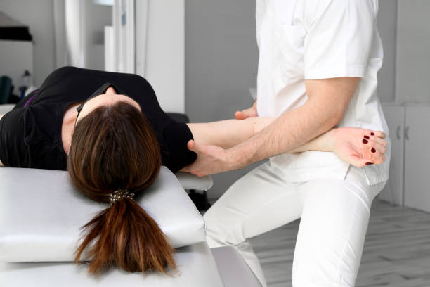 Midsection Of Chiropractor Doing Bone Adjustments At Clinic Midsection Of Chiropractor Doing Bone Adjustments At Clinic chiropractors stock pictures, royalty-free photos & images
