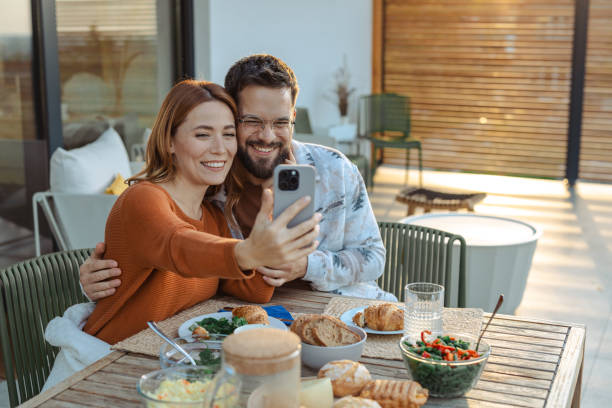 istock Couple enjoying breakfast together while taking a selfie on the patio 2181868275