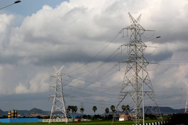 Powerline cables over the blue sky in agriculture field