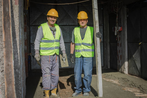 Portrait of two builders at a construction site
