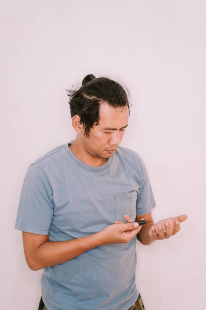 istock Southeast Asian man testing blood sugar with a diabetes device on his finger 2181872256