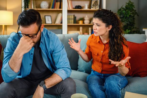 istock Mid adult couple arguing on sofa at home. 2181872775