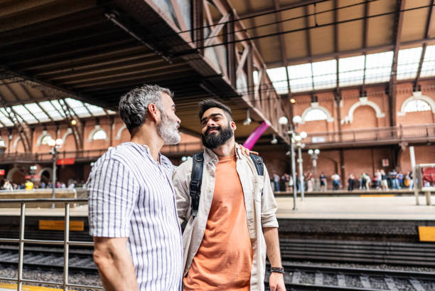 istock Gay couple talking at subway station 2181874581