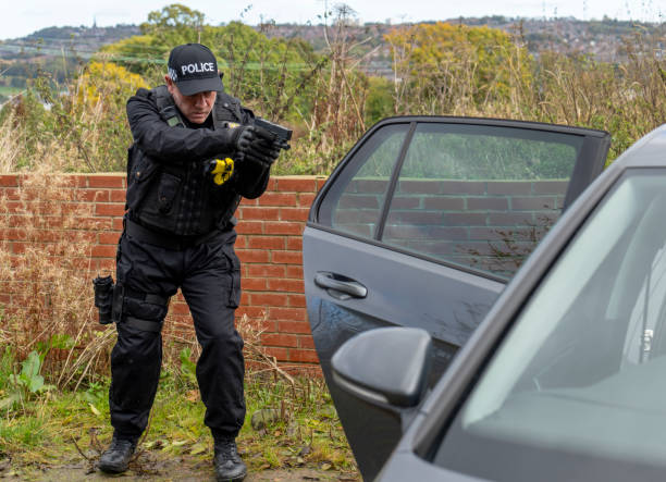 istock Armed UK police officer wearing baseball cap 2181877209