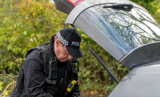 istock Armed UK police officer wearing baseball cap 2181877347