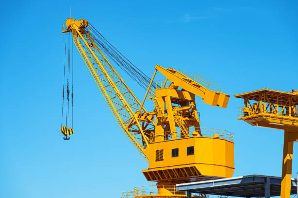 Commercial dock crane with sunny blue sky background