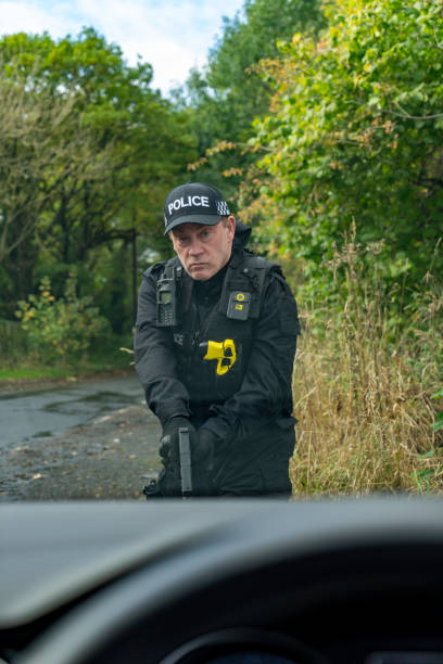 istock Armed UK police officer wearing baseball cap 2181879095