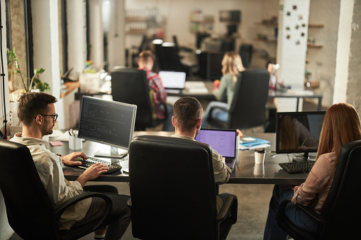 Rear View Of Computer Programmers Working In The Office Stock Photo ...