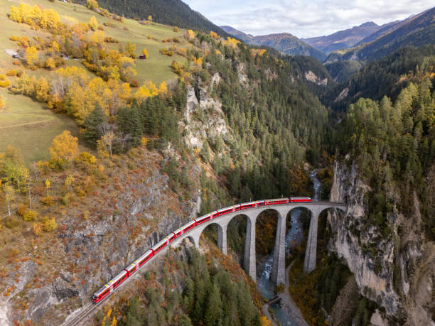 istock Red Train Crossing Scenic Viaduct Over Mountain Gorge in Autumn 2181883340