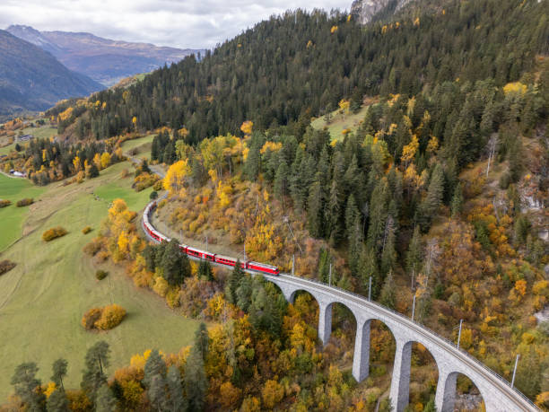 istock Red Train Crossing Scenic Viaduct Over Mountain Gorge in Autumn 2181883437