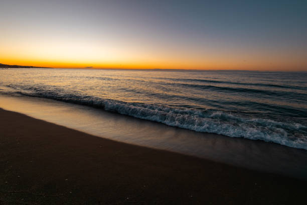 istock beautiful sunrise on the sea with waves 2181885004