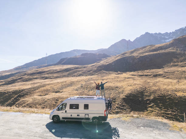 istock Adventurous Couple Celebrating atop Camper Van in Mountains 2181888463