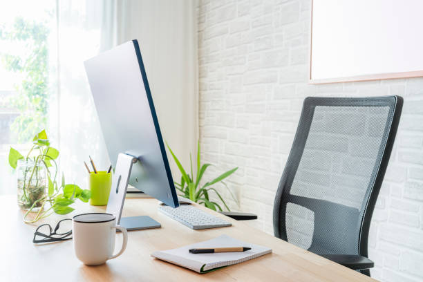 istock Modern office desk with computer, houseplant, coffee cup and various office supplies 2181892174