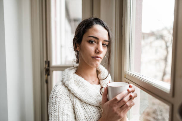 istock sad woman at the window 2181893840