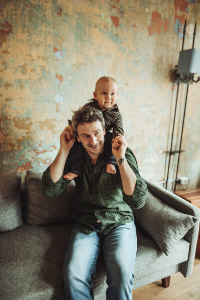 istock father holding the son on the shoulder 2181895733