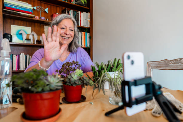 istock Senior woman doing live streaming talking about plants at home 2181896397