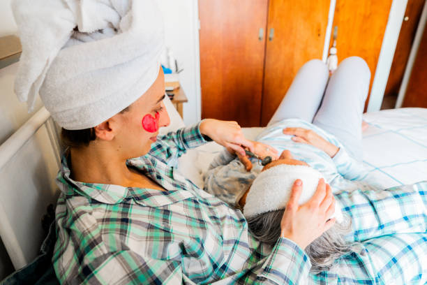 istock Daughter massaging mother lying on bed at home 2181896490