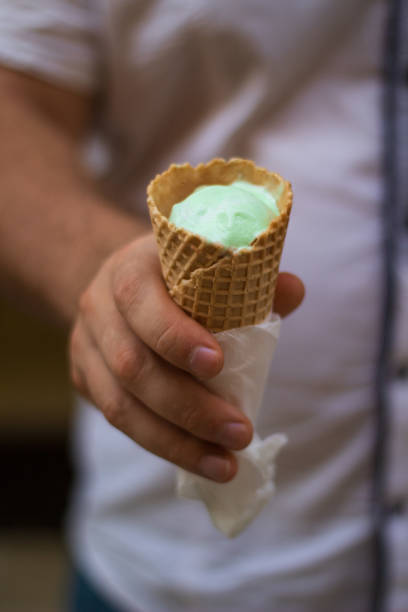 istock Man Holding Ice Cream in a Waffle Cone 2181896808