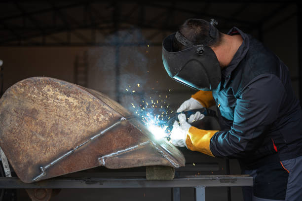 istock Metal worker welding metal part wearing protective gear 2181899706