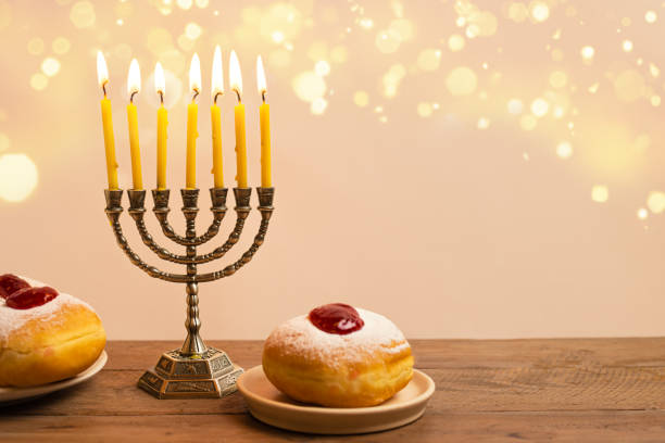 istock Hanukkah composition with Menorah, candles and sufganiyah jelly donuts 2181899898