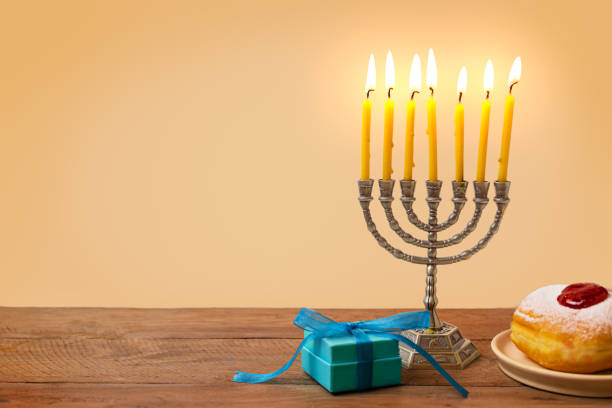 istock Hanukkah Menorah, candles and sufganiyah jelly donuts 2181899916
