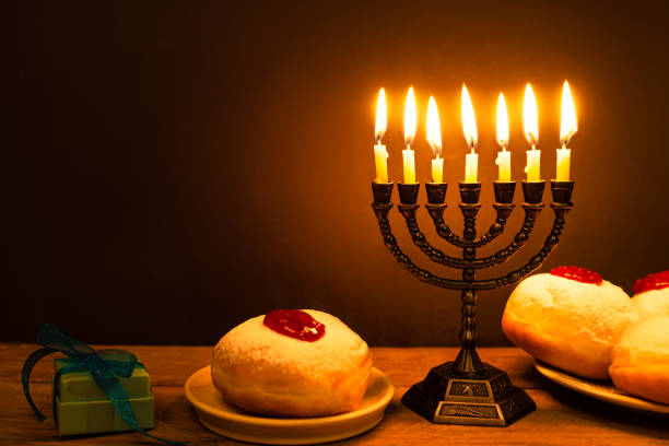istock Hanukkah symbols: Menorah candles and sufganiyah jelly donuts 2181899996