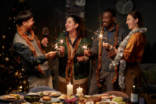 Cheerful People Holding Bengal Lights while Celebrating Christmas at Home
