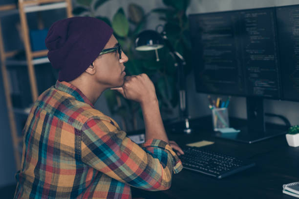 istock Photo of thoughtful cool businessman dressed hat glasses debugging problems modern device indoors workplace workstation loft 2181901775