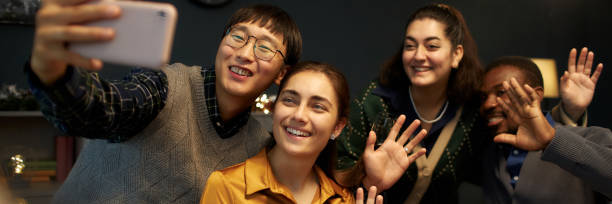 istock Smiling People Waving Hands Taking Selfie while Celebrating Christmas at Home 2181903939