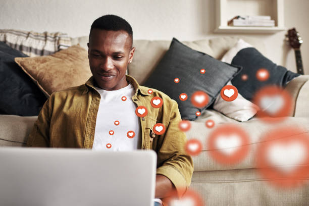 istock Laptop, love icon or black man on social media for communication, text conversation or online dating. Like, graphic overlay or relaxed happy person on website or digital network app with heart emoji 2181906049