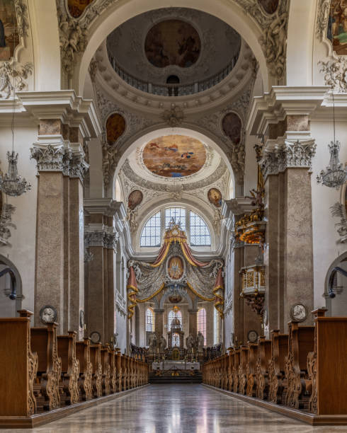 The exquisite and magnificent interior of the St, Mang Abbey in Füssen The monastery and the former Basilica of St. Mang date back to St. Magnus, an Irish missionary from the monastery of St. Gallen who worked in the Allgäu in the 8th century. Above his cell was the first church, which was extended and built over in the course of the centuries. The church was extended to its present size between the 11th and 14th centuries. The tower dates from 1200 and was ravaged and looted in the Thirty Years’ War, St. Mang was rebuilt in the Italian Baroque style by Johann Jakob Herkomer at the beginning of the 18th century. A light-flooded room, frescoes and marble characterize this style. The text was writen by myself st mang stock pictures, royalty-free photos & images